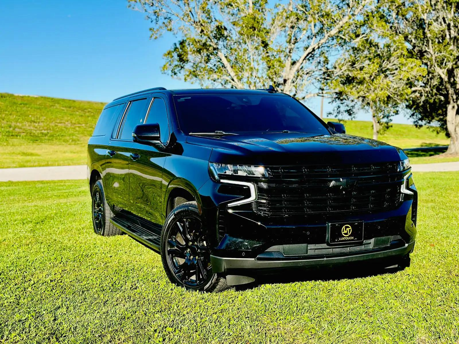 Clean glossy black SUV after professional hand car washing in Houston